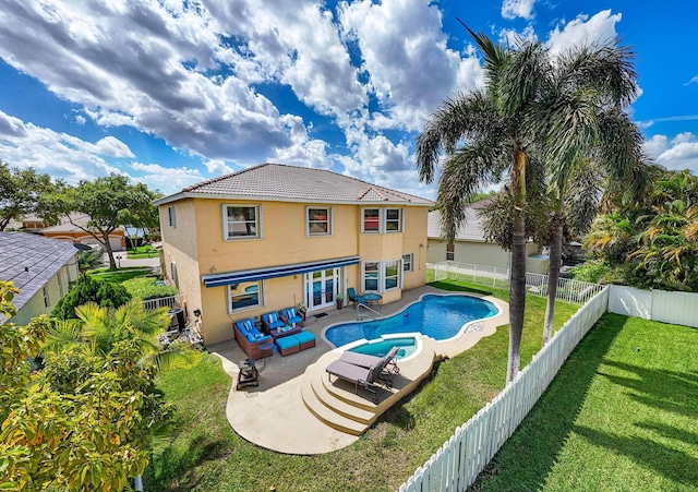 rear view of property with stucco siding, a patio, a fenced backyard, a yard, and french doors