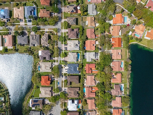 drone / aerial view featuring a residential view and a water view