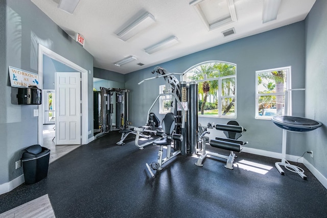 workout area with visible vents and baseboards