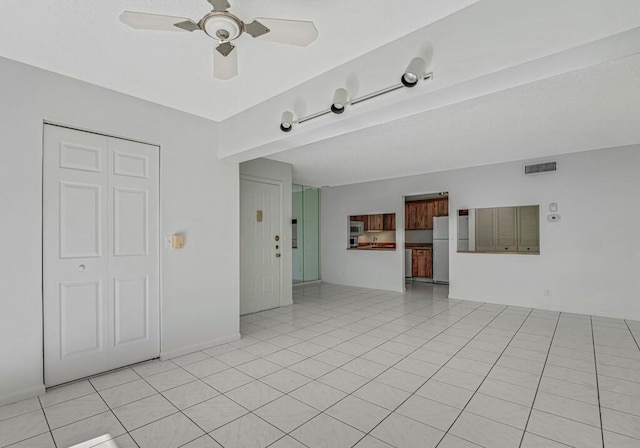 empty room with visible vents, ceiling fan, and light tile patterned flooring