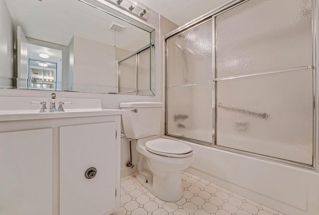 full bathroom featuring visible vents, enclosed tub / shower combo, vanity, and toilet