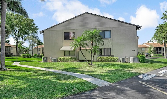 view of property exterior featuring cooling unit, a yard, and stucco siding