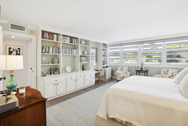 bedroom featuring visible vents and wood finished floors