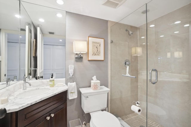 full bathroom featuring visible vents, a shower stall, toilet, and vanity