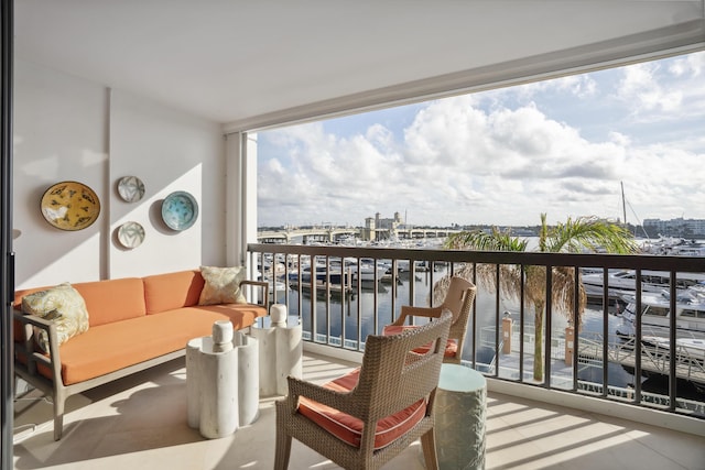 balcony featuring a water view and a city view