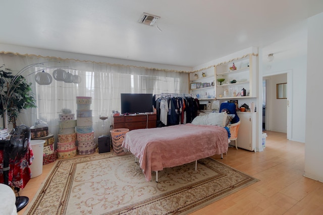 bedroom featuring light wood-type flooring and visible vents