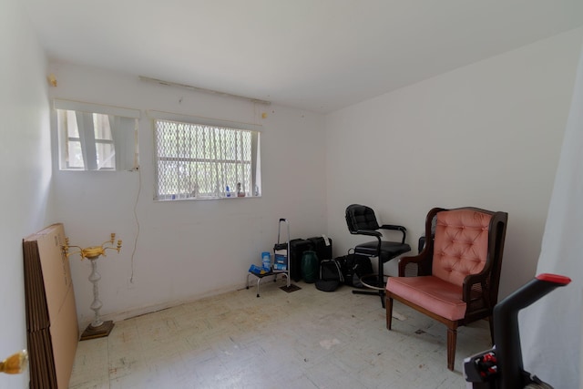 sitting room featuring radiator heating unit and tile patterned floors