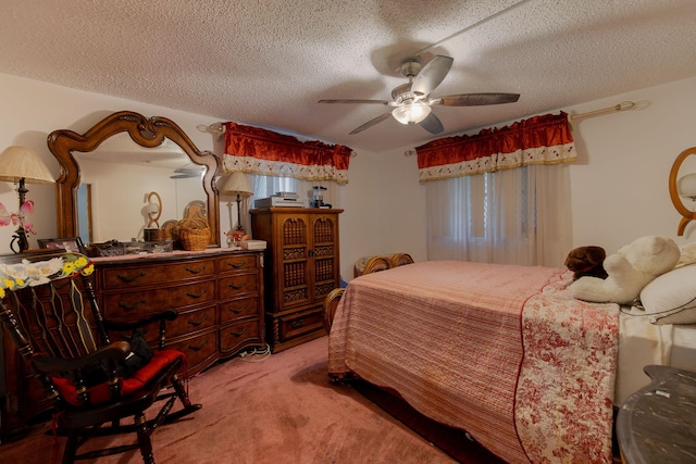 bedroom with a ceiling fan, light carpet, and a textured ceiling