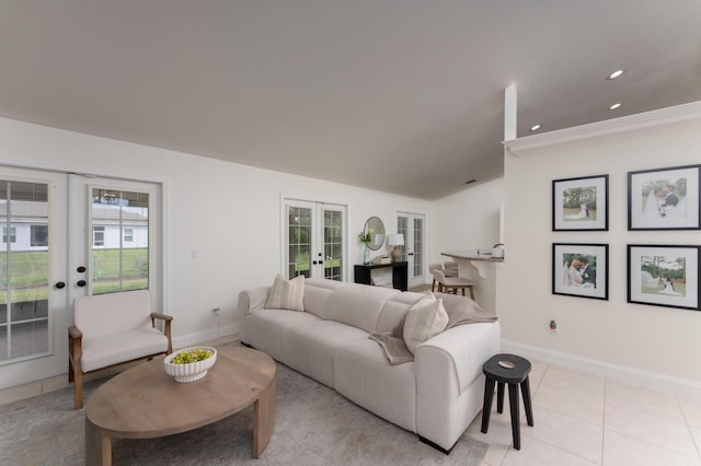 living area with french doors, plenty of natural light, baseboards, and light tile patterned floors