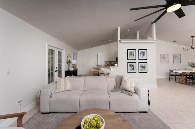 living room with french doors, light tile patterned flooring, vaulted ceiling, and baseboards