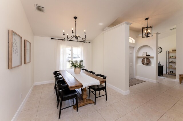 dining area featuring lofted ceiling, visible vents, a notable chandelier, and light tile patterned flooring