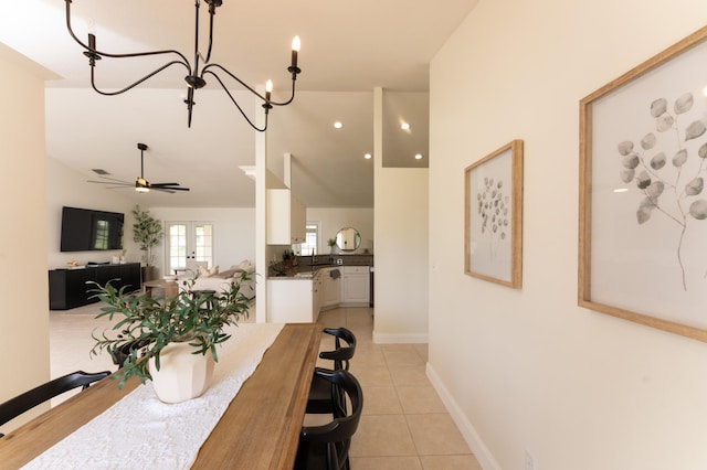 dining space with french doors, lofted ceiling, a ceiling fan, light tile patterned flooring, and baseboards