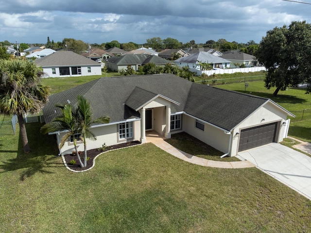 ranch-style house featuring roof with shingles, stucco siding, an attached garage, a front yard, and fence