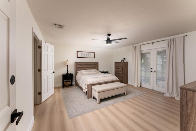 bedroom featuring visible vents, a ceiling fan, light wood-style flooring, access to outside, and french doors