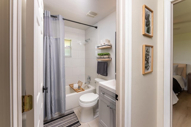 ensuite bathroom featuring connected bathroom, toilet, vanity, visible vents, and shower / bath combination with curtain