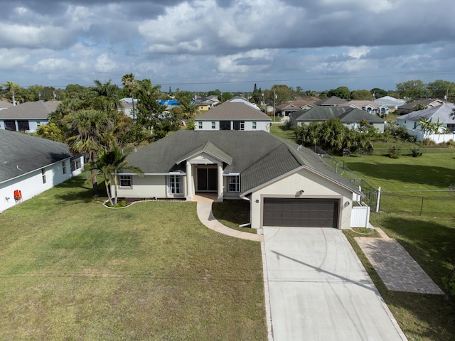 view of front facade featuring a garage, concrete driveway, fence, a front lawn, and stucco siding