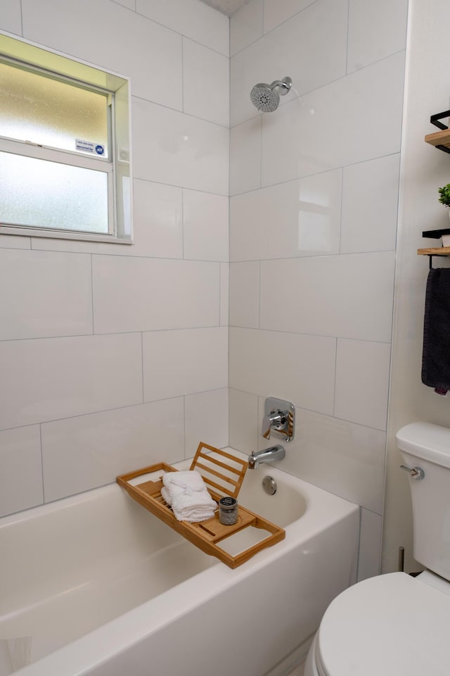 bathroom with tub / shower combination and toilet