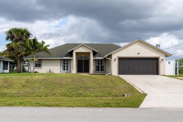 ranch-style house with concrete driveway, an attached garage, fence, a front lawn, and stucco siding