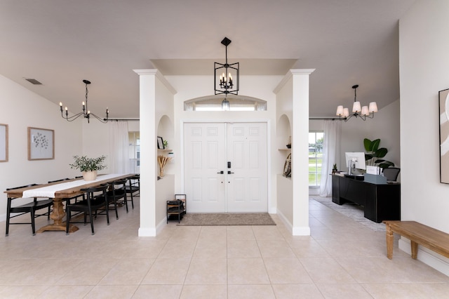 entrance foyer with a chandelier, light tile patterned flooring, visible vents, and baseboards