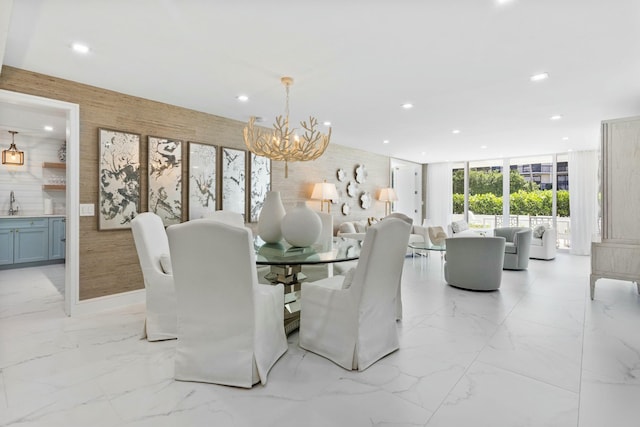 dining area with recessed lighting, expansive windows, a notable chandelier, and marble finish floor