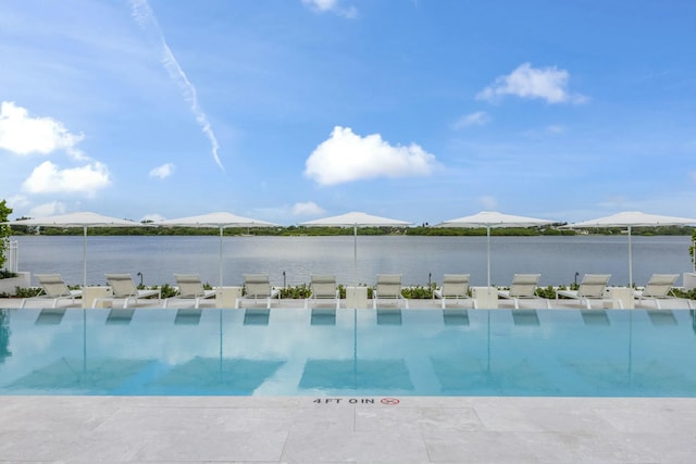 view of swimming pool with a water view