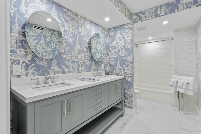 bathroom featuring wallpapered walls, toilet, and a sink