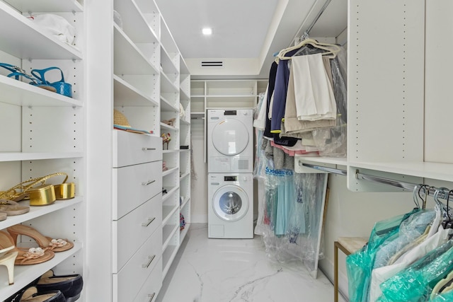 walk in closet with stacked washer and dryer