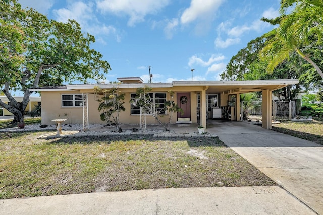 ranch-style home featuring an attached carport, concrete driveway, and stucco siding