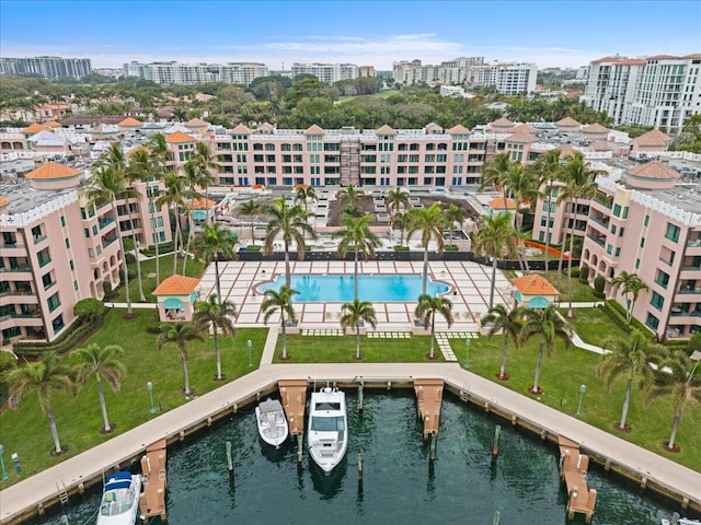 birds eye view of property with a city view and a water view