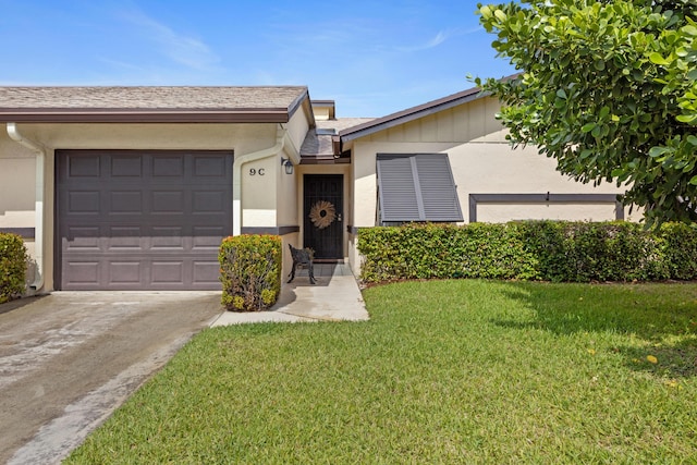 single story home featuring stucco siding, driveway, a front lawn, and a garage