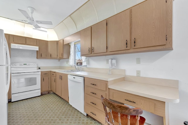 kitchen featuring a sink, under cabinet range hood, white appliances, light countertops, and light floors