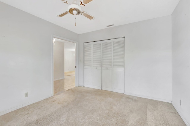 unfurnished bedroom featuring a closet, carpet flooring, baseboards, and visible vents