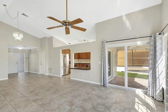 unfurnished living room featuring visible vents, baseboards, ceiling fan with notable chandelier, light tile patterned flooring, and high vaulted ceiling