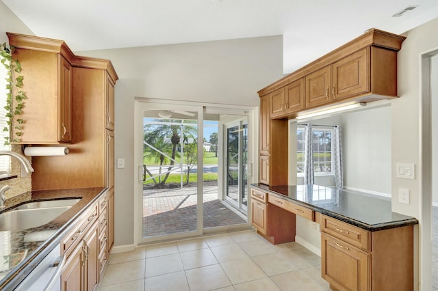 kitchen with visible vents, light tile patterned floors, dishwashing machine, built in study area, and a sink