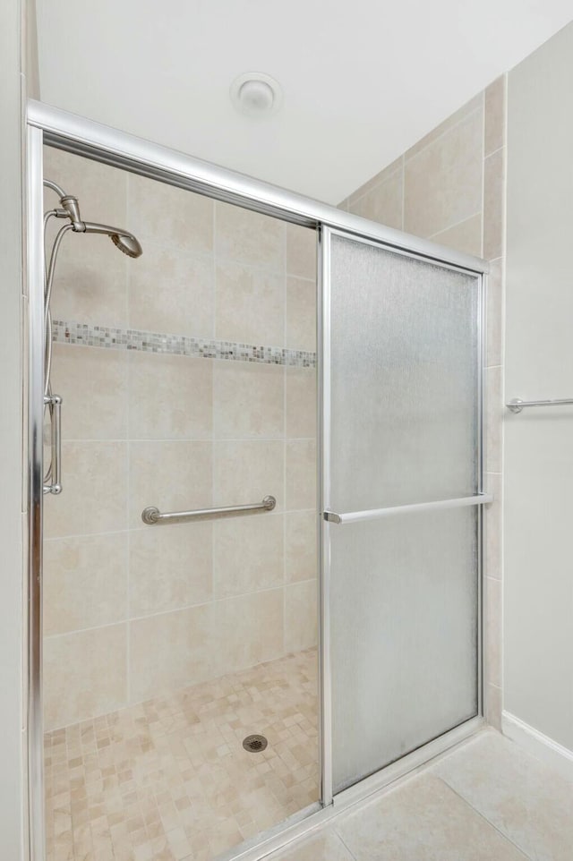 full bath with tile patterned flooring and a stall shower