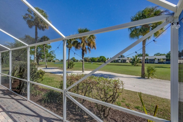 view of yard with glass enclosure