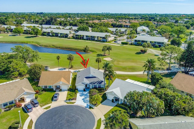 birds eye view of property featuring golf course view, a water view, and a residential view