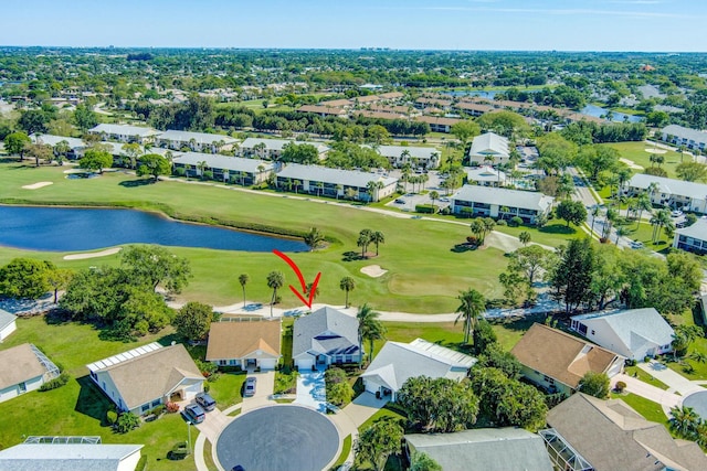 birds eye view of property featuring view of golf course, a water view, and a residential view