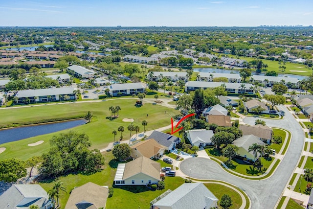 birds eye view of property with a residential view, golf course view, and a water view