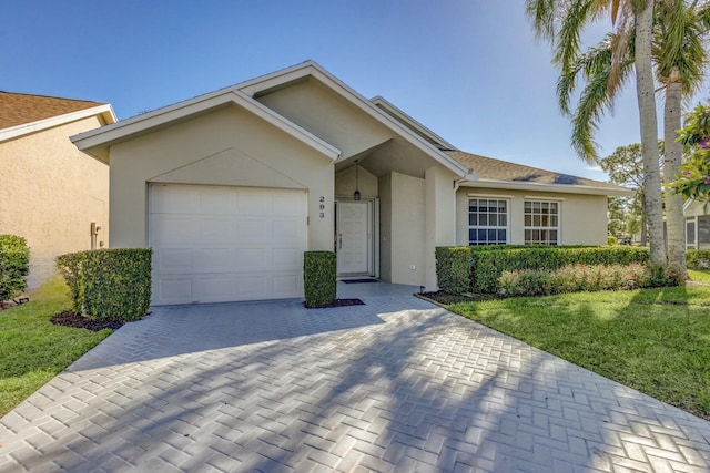 ranch-style house featuring decorative driveway, a front lawn, an attached garage, and stucco siding