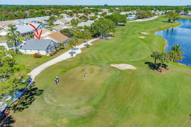 aerial view featuring a residential view, golf course view, and a water view