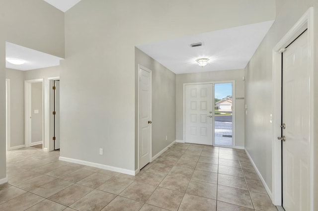 entryway featuring light tile patterned floors, visible vents, and baseboards