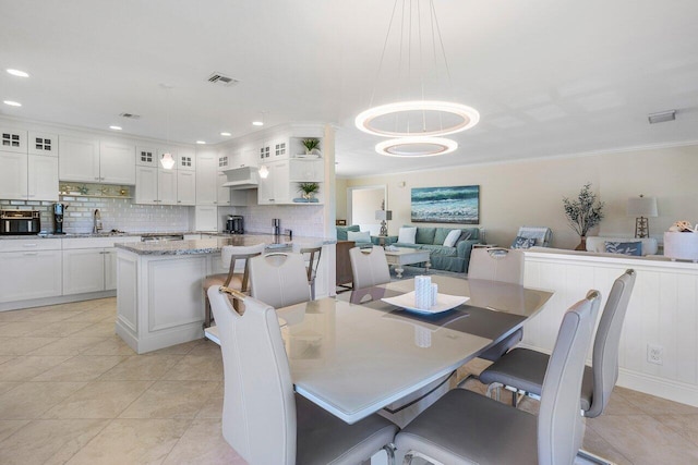 dining room featuring recessed lighting, visible vents, light tile patterned flooring, and crown molding