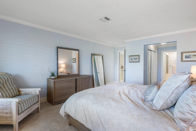 bedroom featuring visible vents, ensuite bath, a closet, crown molding, and baseboards