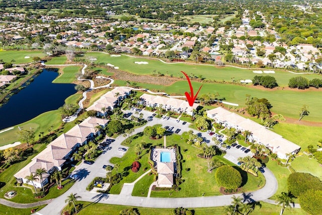 drone / aerial view featuring a residential view, a water view, and view of golf course