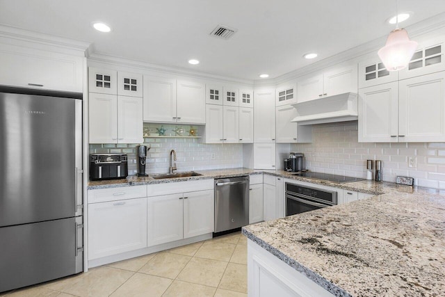 kitchen featuring a sink, stainless steel appliances, under cabinet range hood, and white cabinets