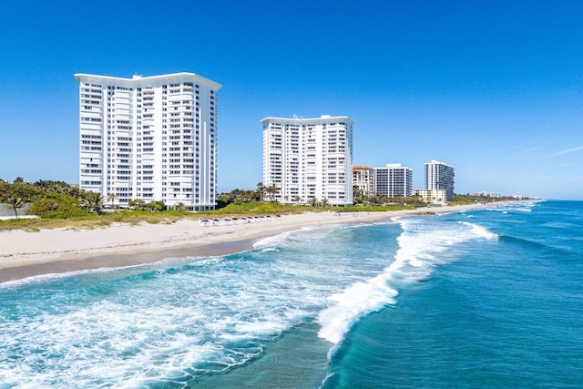 property view of water featuring a view of city and a beach view