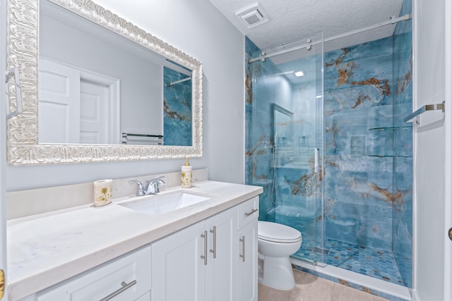 bathroom with visible vents, toilet, a stall shower, a textured ceiling, and vanity