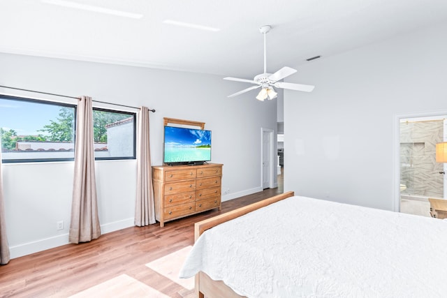 bedroom featuring a ceiling fan, baseboards, visible vents, light wood-type flooring, and connected bathroom