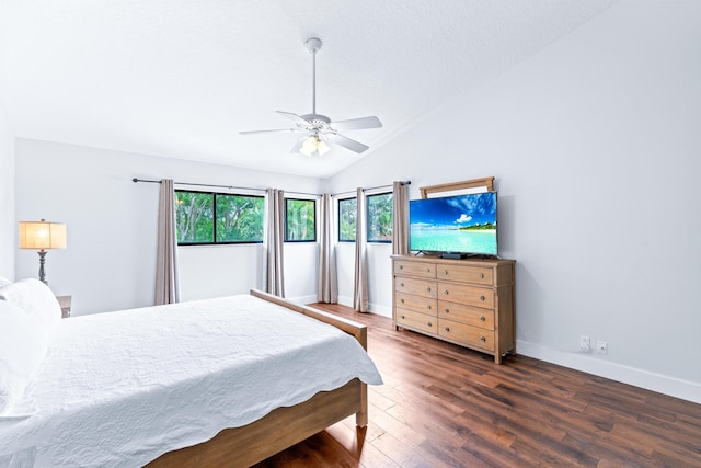 bedroom with lofted ceiling, wood finished floors, baseboards, and ceiling fan